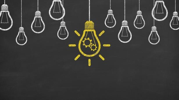 Idea solution concepts with light bulbs on a chalkboard background