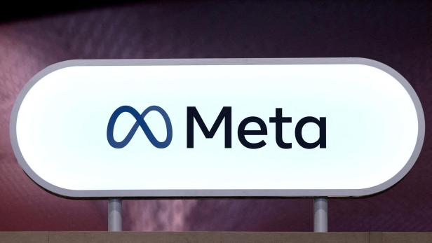 Leuchtendes Schild mit dem Meta-Logo und dem Schriftzug „Meta“ auf hellem Hintergrund.