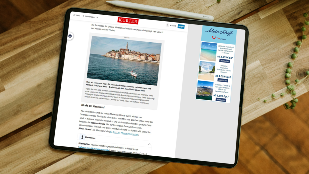 Tablet mit geöffneter KURIER-Webseite, auf der ein Artikel mit Reiseangeboten und einer Anzeige für TUI Cruises zu sehen ist.
