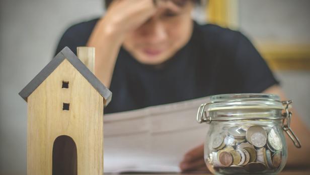 Young man checking bills and having financial problems with home debt, Money concept., real estate, buy an apartment