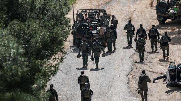 Israeli soldiers gather on the Israeli side of the Israel-Lebanon border