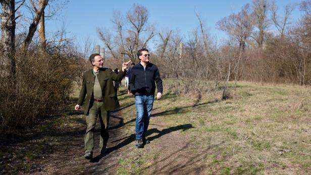 Alexander Mrkvicka und Jürgen Czernohorszky spazieren auf einem Pfad durch eine herbstliche Landschaft.