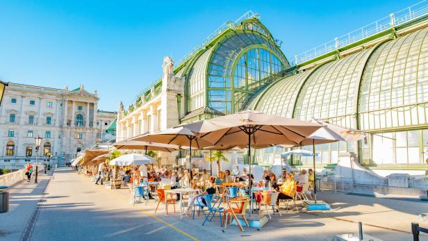 Summer street cafe in Vienna old town, Butterfly House (Schmetterlinghaus) on background