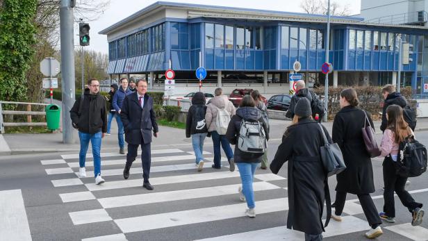 Menschen überqueren Zebrastreifen