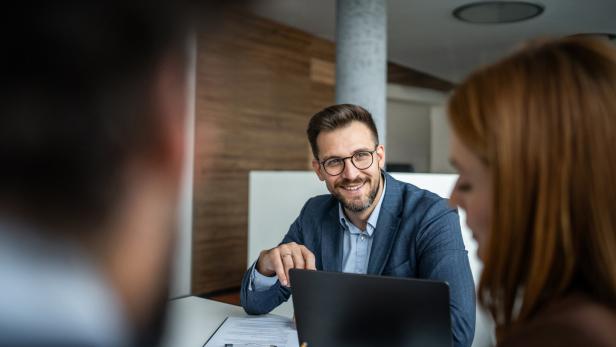 Financial advisor consulting clients in office meeting