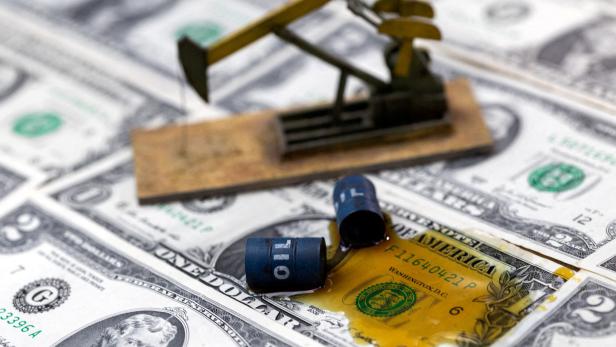 FILE PHOTO: Illustration shows oil, miniatures of oil barrels and U.S. dollar banknote
