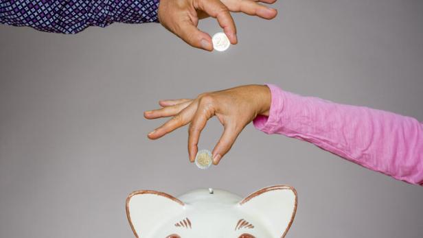 crowdfunding - people inserting money into piggybank