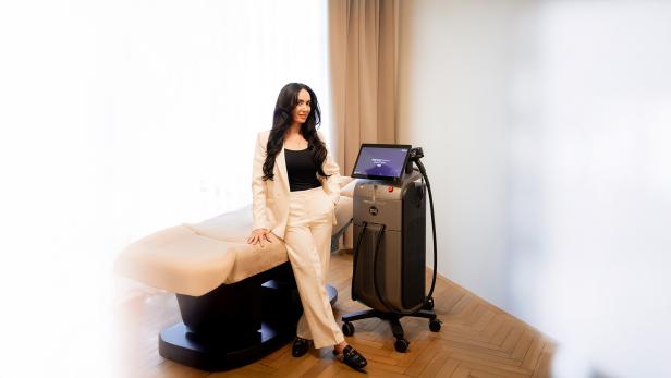 Eine Frau steht in einem Ordinationszimmer für Laserbehandlungen.