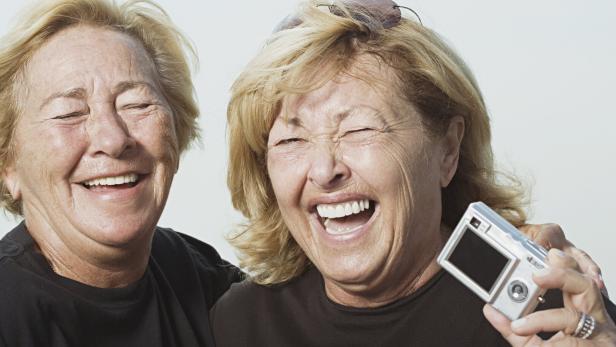 Laughing women with digital camera