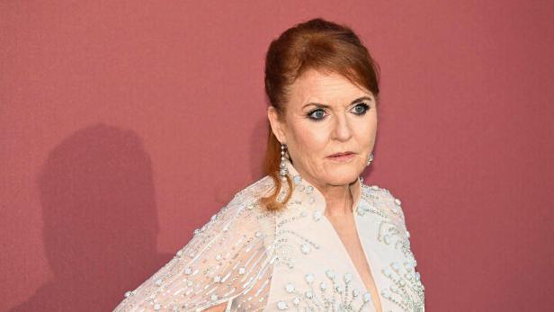 Sarah Ferguson, mit hochgesteckten roten Haaren und einem verzierten Kleid, blickt zur Seite.
