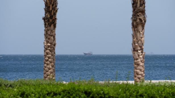 A boat is off the coast of Musandam governorate, overlooking the strait of Hormuz, in Musandam governance