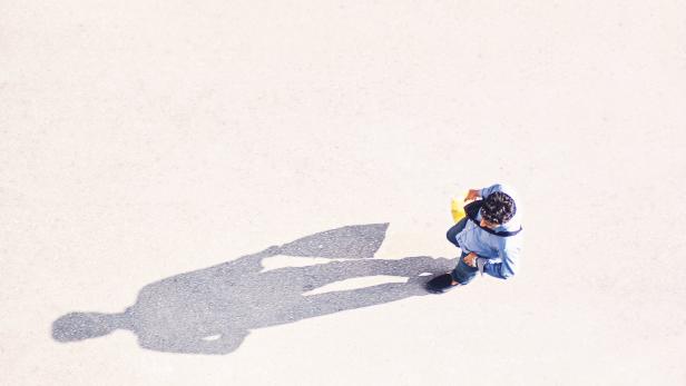 Directly Above Shot Of Man Walking On Road