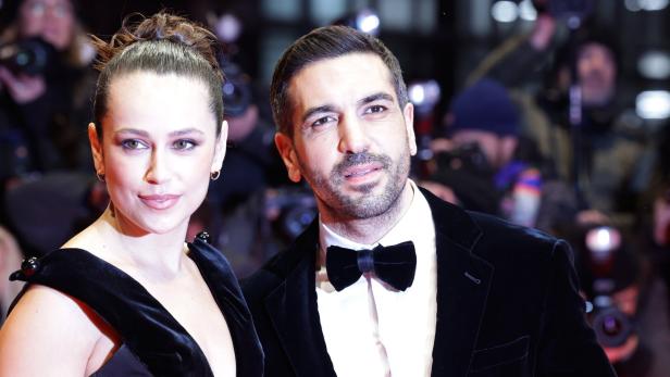 Elyas M'Barek und Jessica Riso M'Barek posieren auf einem roten Teppich.