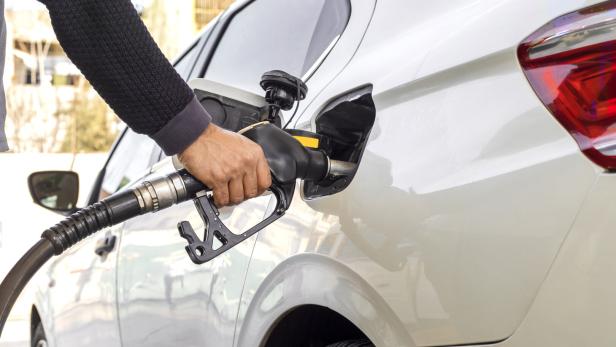 Man hand refuelling the car, Pumping gasoline fuel in car at petrol station. higher oil prices
