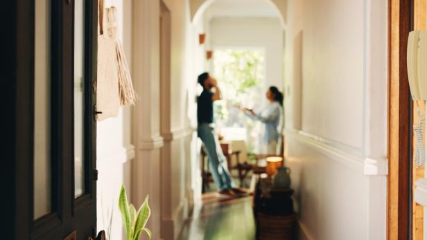 Frustrated couple, fight or hallway with argument, conflict or disagreement for breakup in home. Angry, man and woman shouting with dispute for toxic relationship, cheating affair or divorce in house