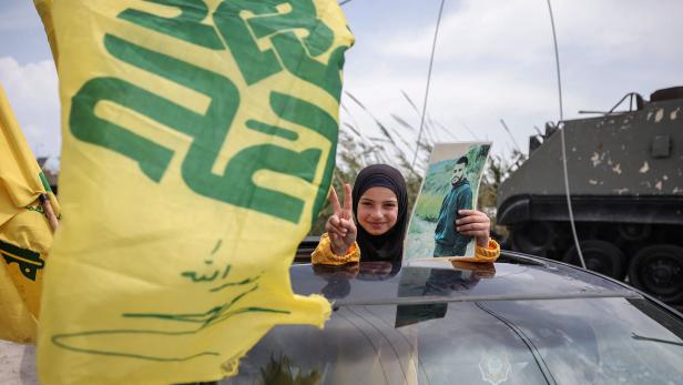 Displaced people cross the bridge linking southern Lebanon to the rest of the country, which was hit earlier in an Israeli strike, in Qasmiyeh