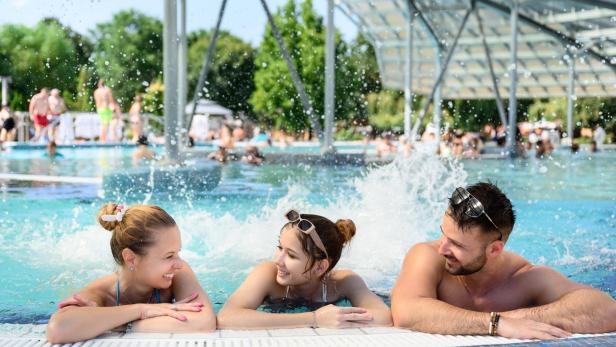 Mutter, Tochter und Vater entspannen in einem Indoor-Pool 