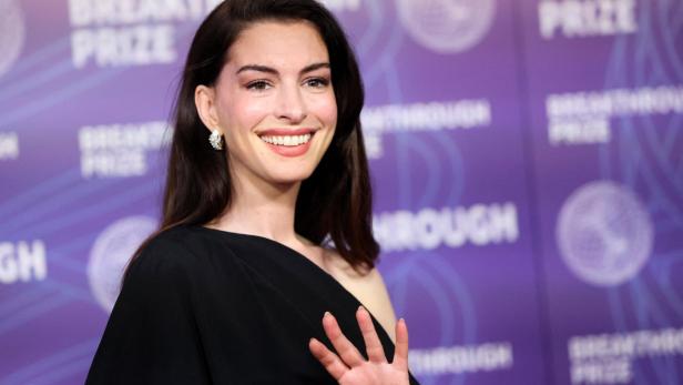 Anne Hathaway winkt