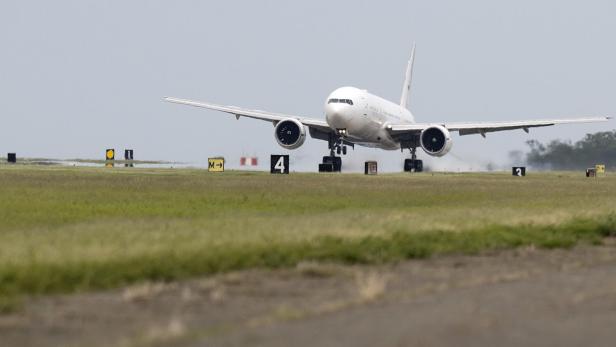 Eine weiße Boeing 777 landet auf dem Flughafen