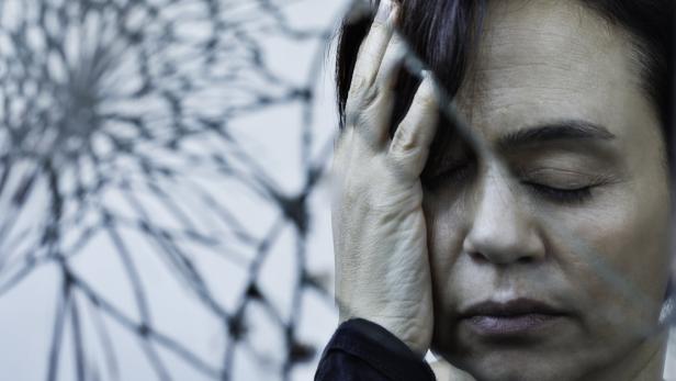 Woman in Distress with Hand on Face and Cracked Glass Effect