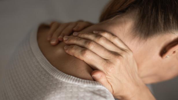 Woman holding her painful spine. Spine injury.
