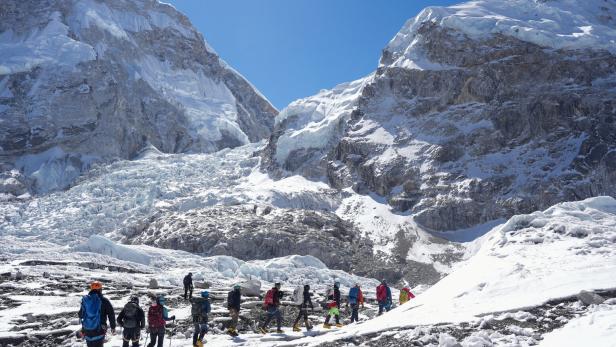 Members of an expedition team hike at Khumbu Icefall in Solukhumbu district, also known as the Everest region, in Nepal