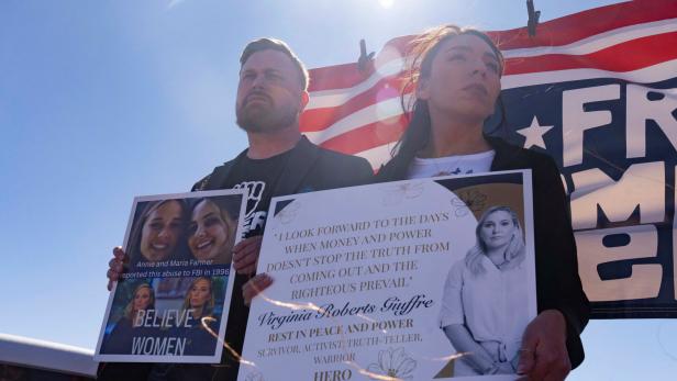 Sky Roberts, brother of Virginia Roberts Giuffre, and Amanda Roberts, sister in law of Virginia Roberts Giuffre, hold signs outside Zorro Ranch, a property formerly owned by Jeffrey Epstein, on International Womens Day near Stanley