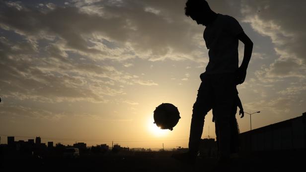 Youths play soccer in Sana'a
