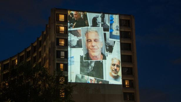 Documents and photos of Jeffrey Epstein and U.S. President Trump projected onto Hilton ahead of WHCA Gala, in Washington, D.C.