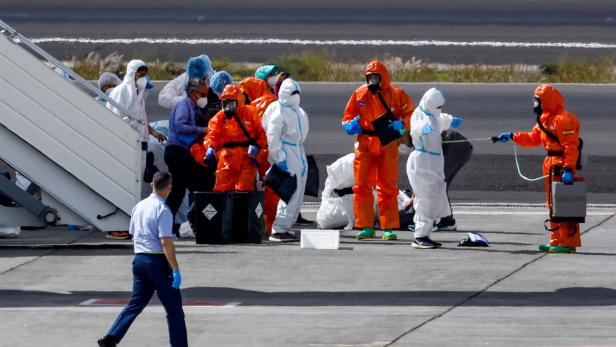 Passengers of the cruise ship MV Hondius, which was affected by a hantavirus outbreak, arrive at Tenerife Sud airport