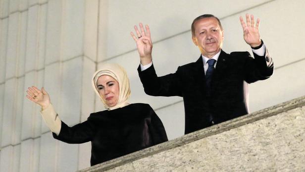 Recep Tayyip Erdoğan und seine Frau Emine winken von einem Balkon.