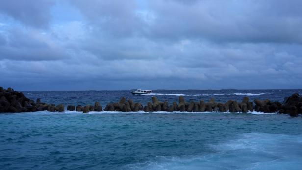 A speed boat moves in the waters of the Indian Ocean near Male