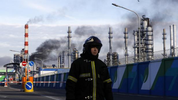 FILE PHOTO: A firefighter is seen on a site, as smoke billows from a fire at oil refinery, owned by Russian oil producer Gazprom Neft, in Moscow
