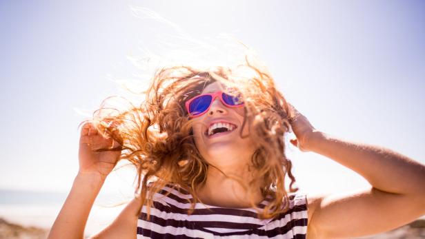 Cheerful laughing woman on the beach