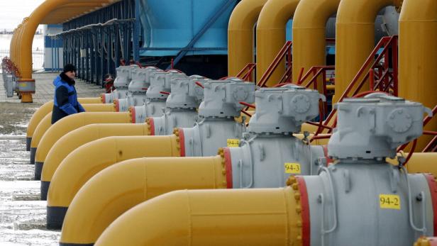 FILE PHOTO: A gas worker walks between pipes in a gas compressor and distribution station near Kursk