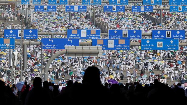 Muslim pilgrims walk on the first day of the Satan stoning ritual, in Mina