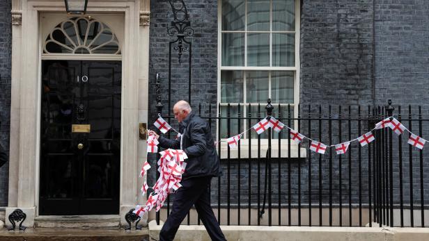 People display flags of England ahead of its match during the Euro 2024 tournament, in London