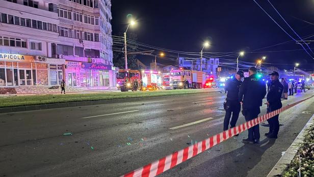 Firefighters and law enforcement work on the site of an explosion at a residential block of flats following a drone hit close to the border with Ukraine