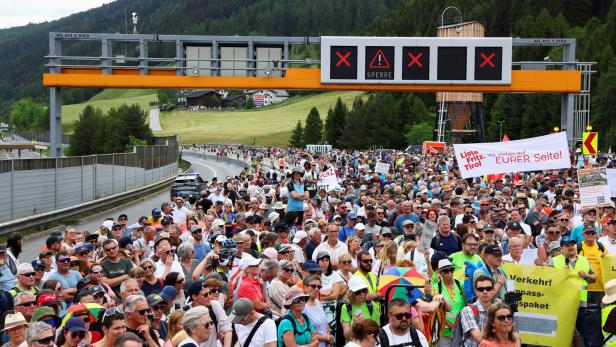 People demonstrate against the growing traffic load, near Matrei