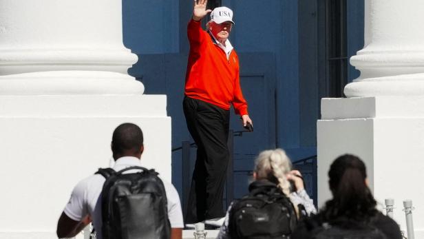 U.S. President Donald Trump waves as he returns to the White House, in Washington