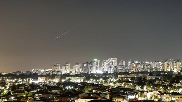 A streak of light illuminates the sky during Missile attack from Iran towards Israel as seen from Ashkelon