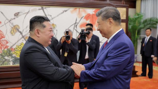 FILE PHOTO: North Korean leader Kim Jong Un and Chinese President Xi Jinping in Beijing