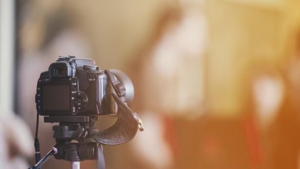 camera on a tripod indoor with beautiful blured background