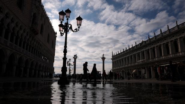 People walk in St. Mark's Square on the first day of the Venice carnival