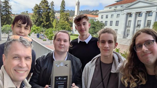 Eine Gruppe junger Menschen hält vor der University of California, Berkeley einen VEX Robotics Judges Award in die Kamera.