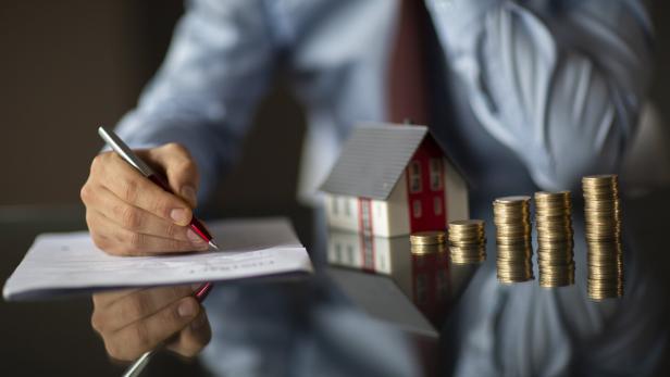 Real estate agent is holding a house model