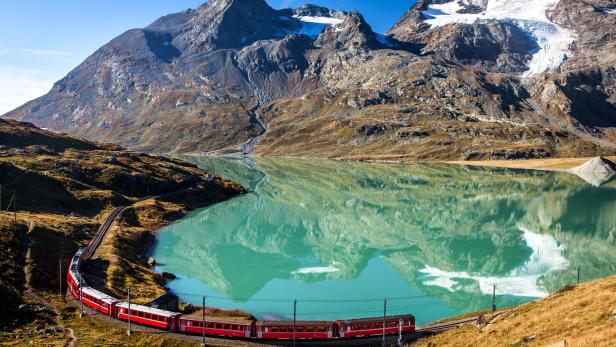 swiss train in the alps mountains in switzerland around ospizio bernina