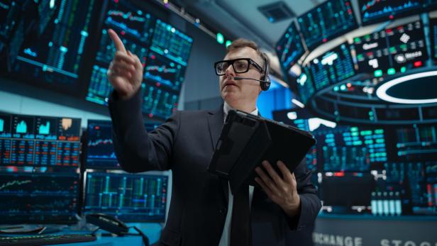 Portrait of a Professional Male Trader Working on Stock Exchange. Enthusiastic Middle Aged Man Shouting, Signaling Orders for Company Shares and Commodities to Brokers at an Open Outcry Arbitrage