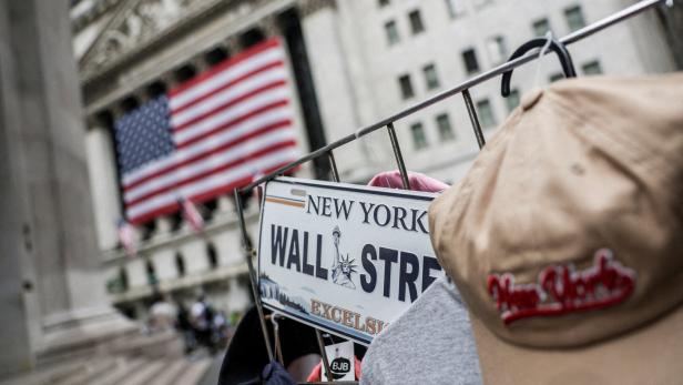 FILE PHOTO: A Wall Street plate is seen on a street vendor stall outside the New York Stock Exchange (NYSE) in New York City