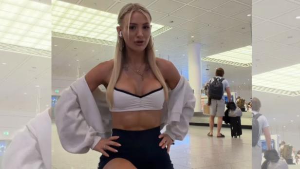 Edda Pilz posiert im Flughafen in Sport-BH und Shorts, bevor sie von Lufthansa wegen ihres Outfits am Boarding gehindert wurde.